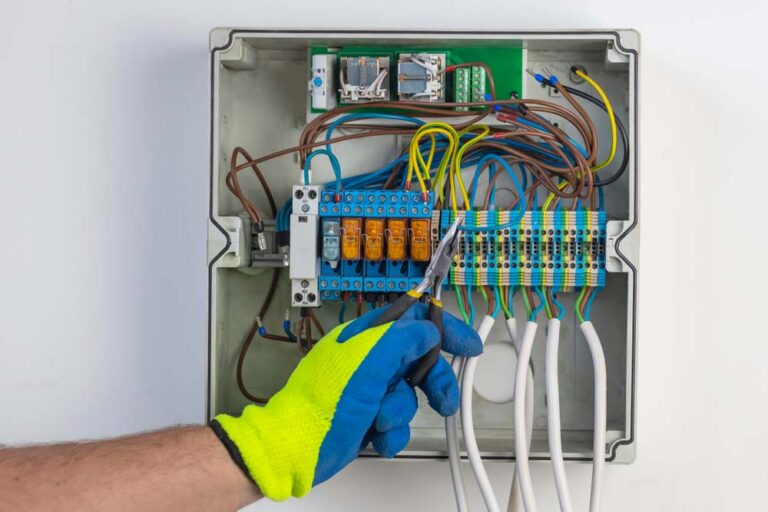 E I Electrical Inc. technician installing a new electrical panel