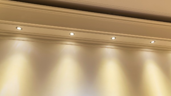 recessed ceiling lights illuminating wall