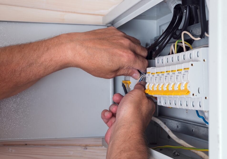 Electrician's,Hands,Skillfully,Connecting,Cables,In,An,Open,Distribution,Board,