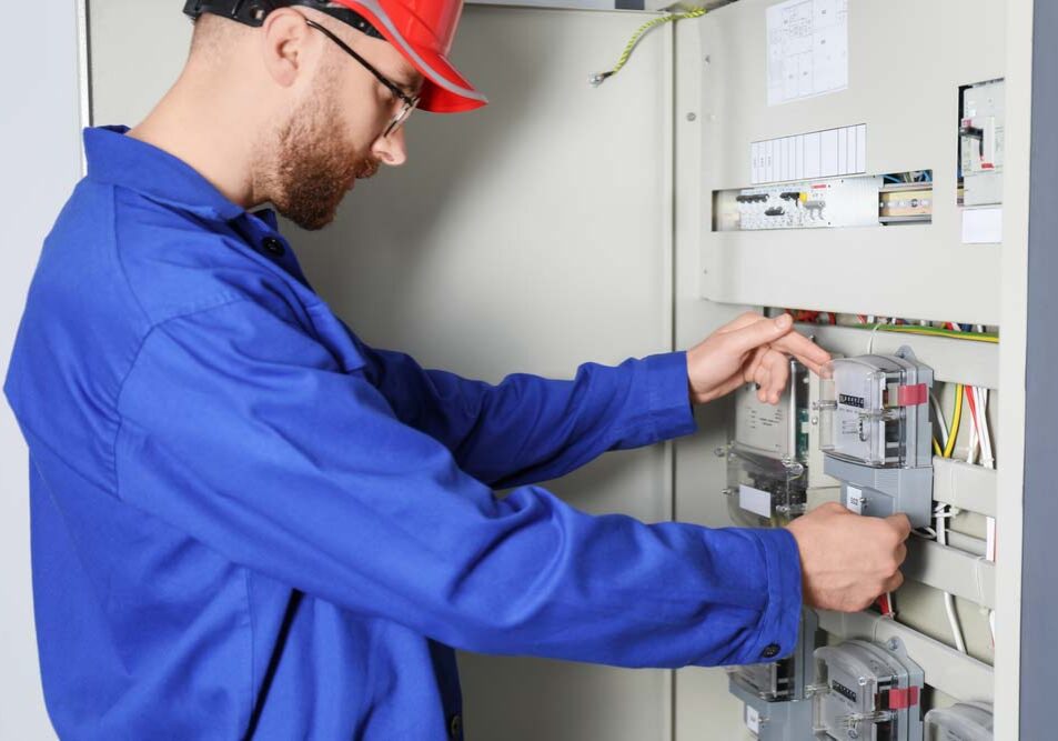 electrician tinkering with an electric meter