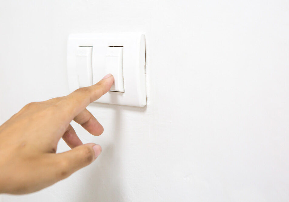 finger flicking a wall switch