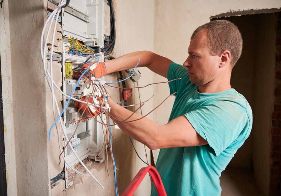 E I technician installing a new electrical panel E I technician installing a new electrical panel