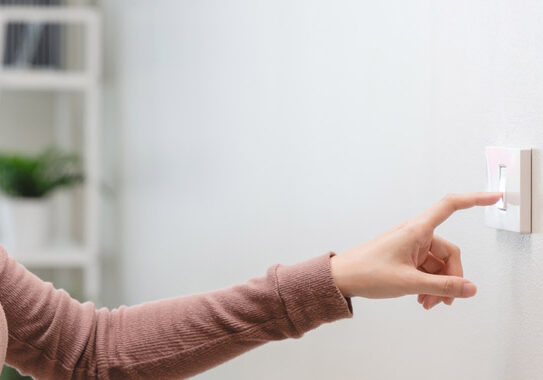 a person turning on a wall switch a person turning on a wall switch