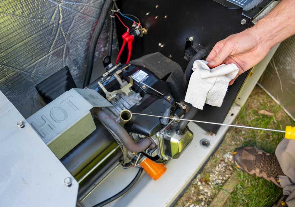 E I Electrical technician servicing a home generator E I Electrical technician servicing a home generator