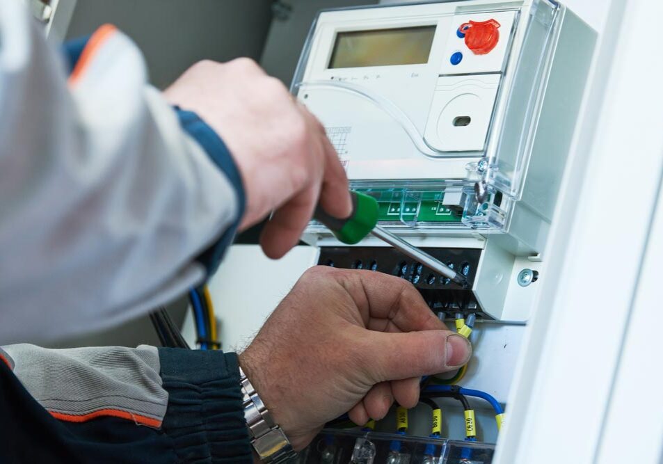 technician tinkering with an electrical meter